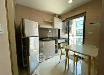 Modern compact kitchen with dining area and natural light