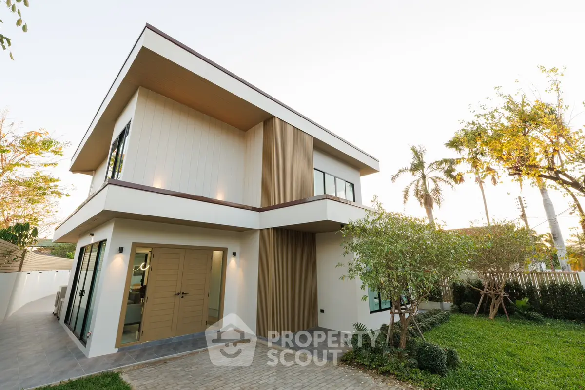 Modern two-story house with sleek design and lush garden