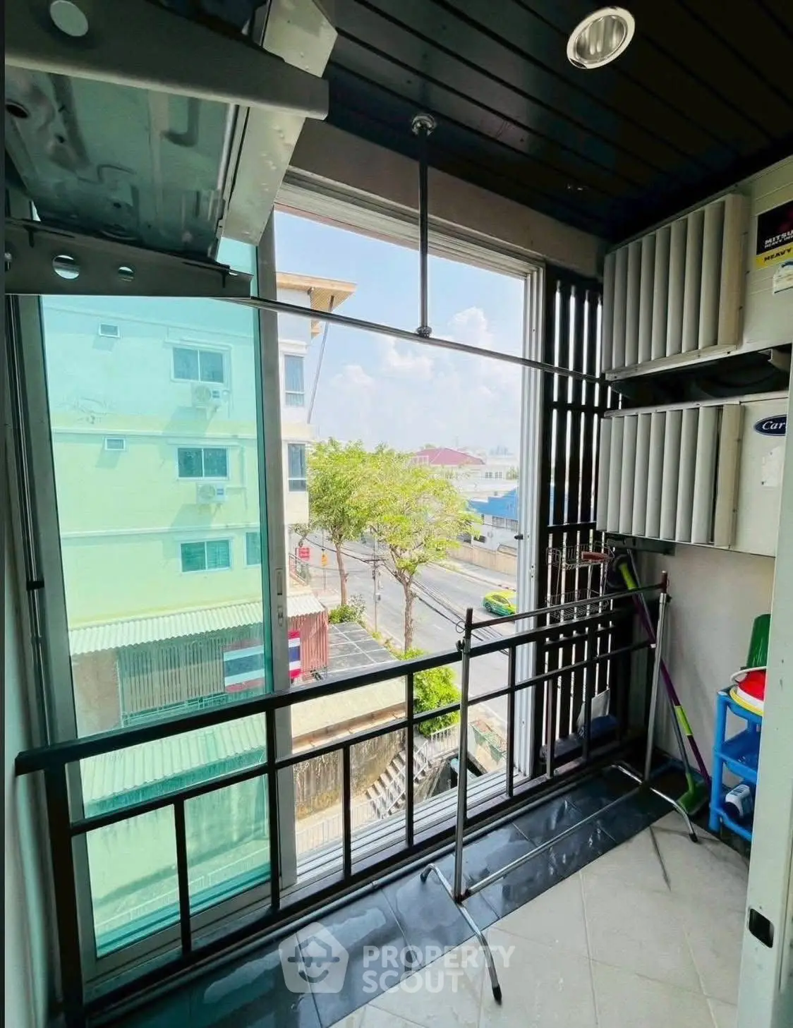 Charming balcony with urban view, perfect for relaxation and enjoying city life.