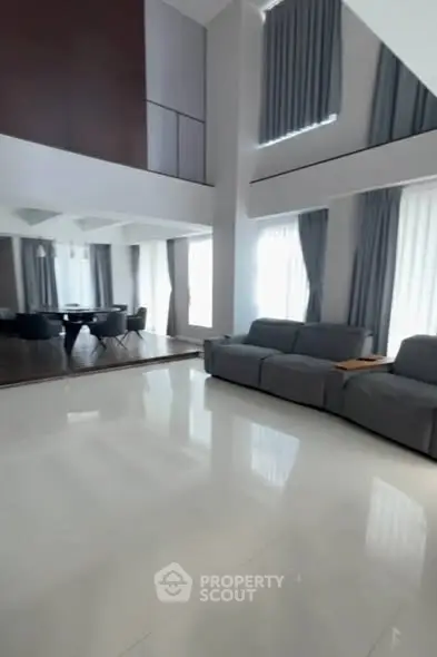 Spacious modern living room with high ceilings and elegant decor