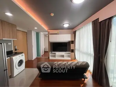 Modern living room with sleek design, featuring a washing machine and stylish furniture.