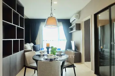 Modern living room with dining area and stylish decor in a cozy apartment.