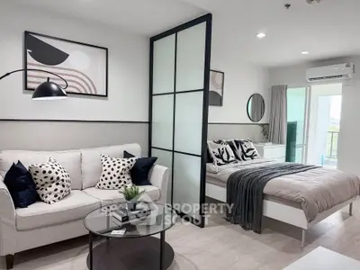 Modern studio apartment with stylish decor and cozy ambiance, featuring a comfortable living area and bedroom.