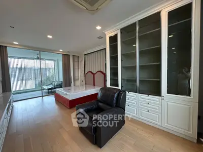 Spacious living room with elegant built-in shelving and large windows for natural light.