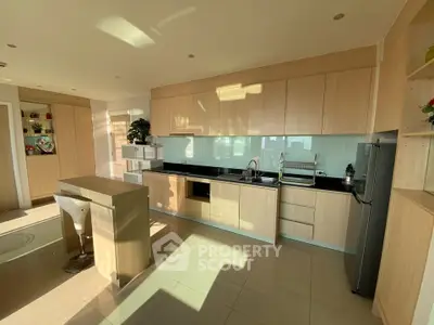 Modern kitchen with sleek cabinetry and island in bright natural light