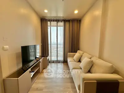 Cozy living room with modern decor and large window offering city views.