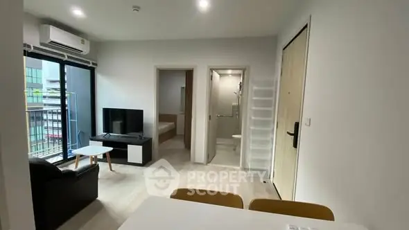 Modern apartment interior with open living space and balcony view.