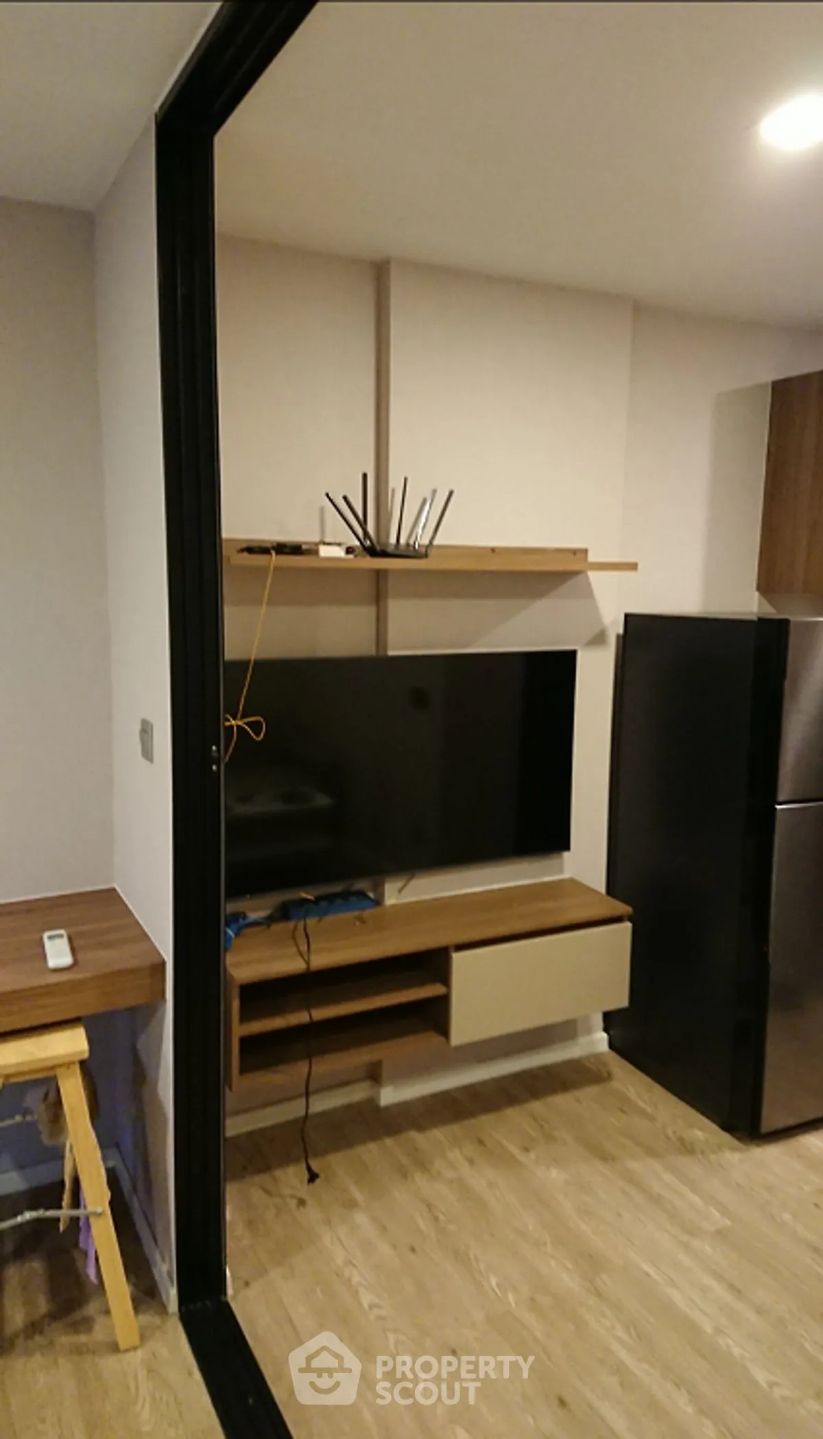 Modern living room with sleek TV unit and wooden flooring