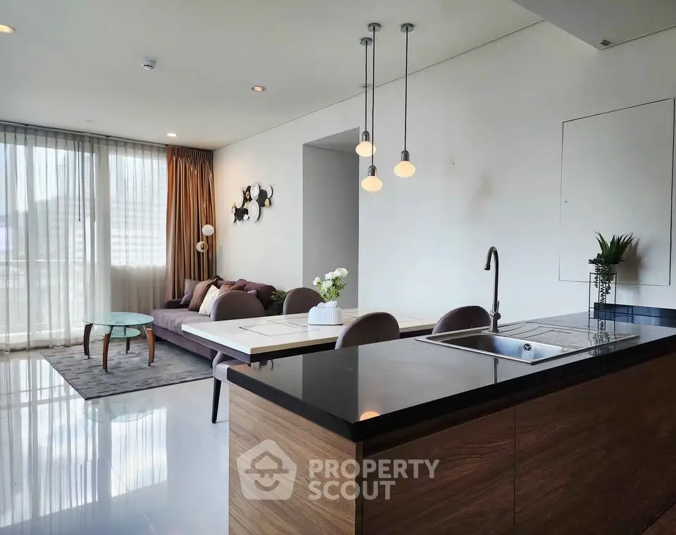 Modern open-plan living room with sleek kitchen island and stylish decor