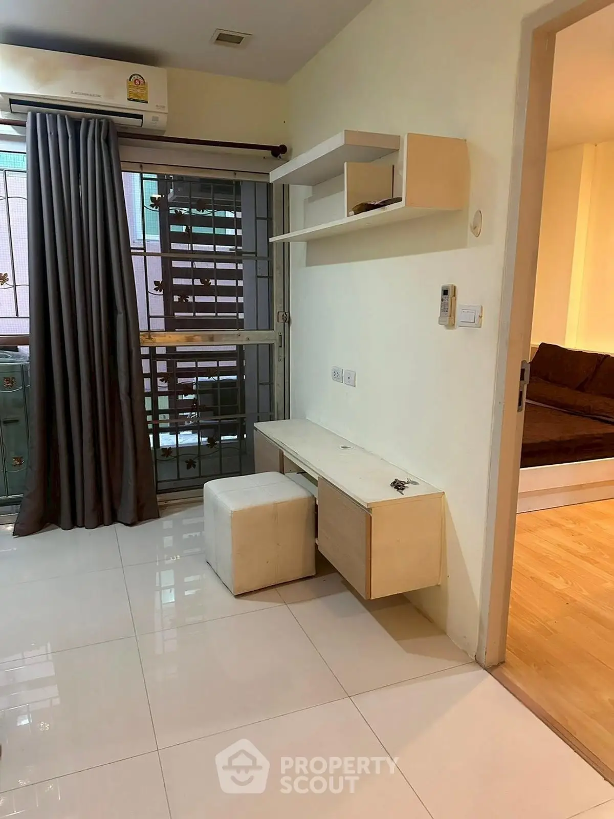 Modern apartment interior with sleek desk and cozy bedroom view