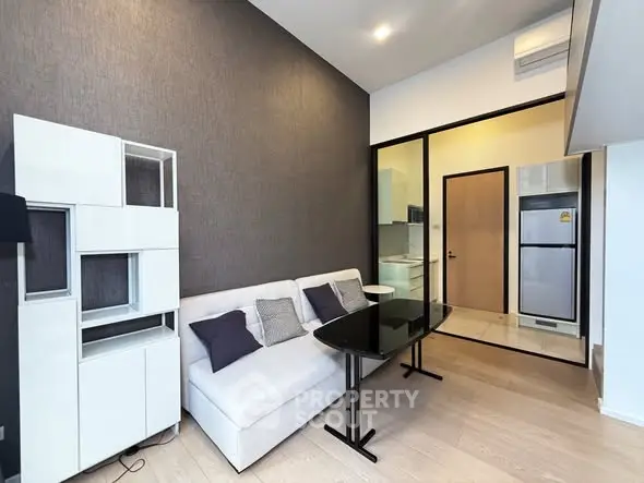 Modern living room with sleek furniture and open kitchen layout