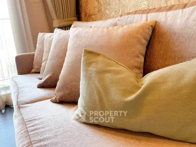Luxurious living room with plush cushions on a stylish sofa, perfect for relaxation and comfort.