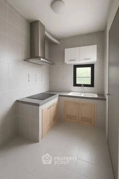 Modern minimalist kitchen with sleek cabinetry and stainless steel range hood.