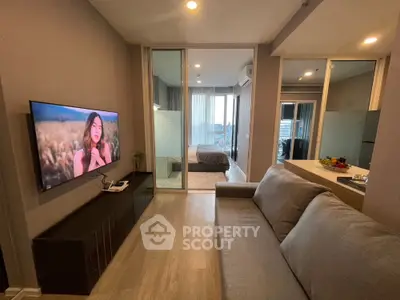 Modern living room with sleek design and open view to bedroom