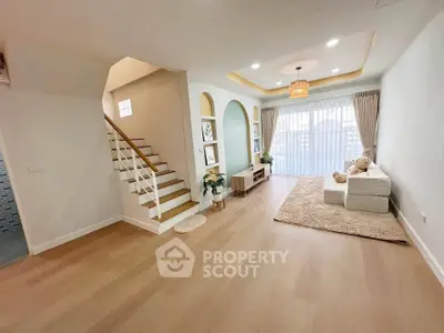 Spacious living room with modern decor and natural light