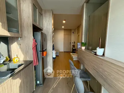 Modern kitchen with wooden cabinetry and breakfast bar in a cozy apartment