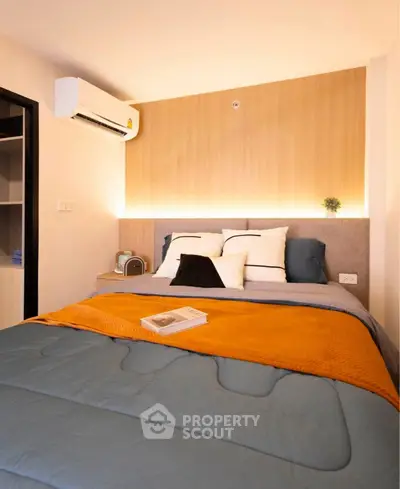 Cozy modern bedroom with stylish decor and ambient lighting, perfect for relaxation and comfort.