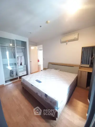 Modern bedroom with wooden flooring and built-in wardrobe
