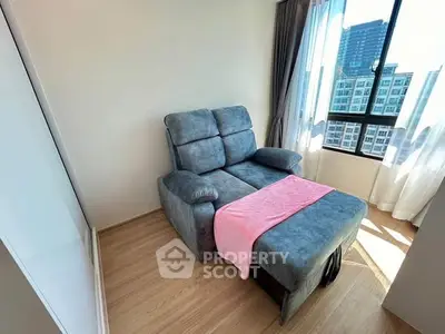 Cozy corner with plush recliner and city view in modern apartment