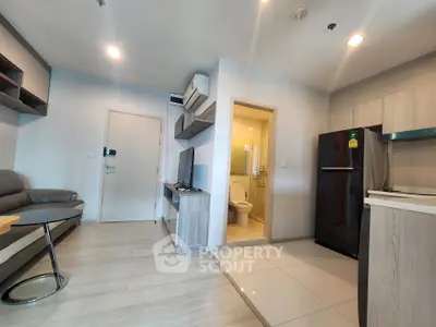 Modern apartment interior with open layout, featuring cozy living area and sleek kitchen design.