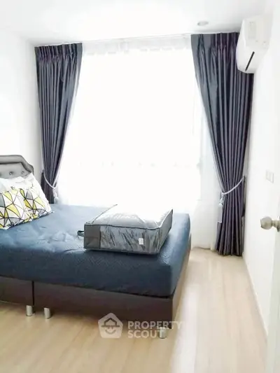 Bright bedroom with modern decor and large window for natural light