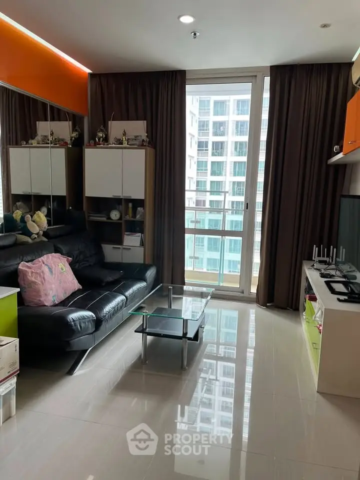 Modern living room with sleek furniture and city view from large window