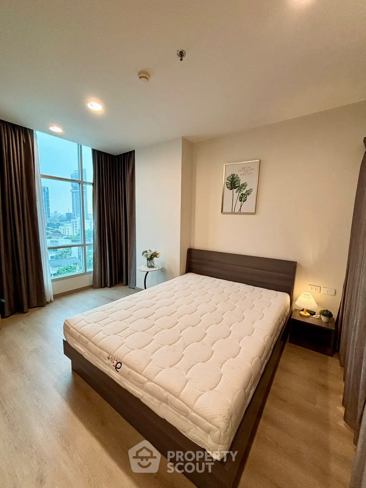 Spacious bedroom with city view and modern decor