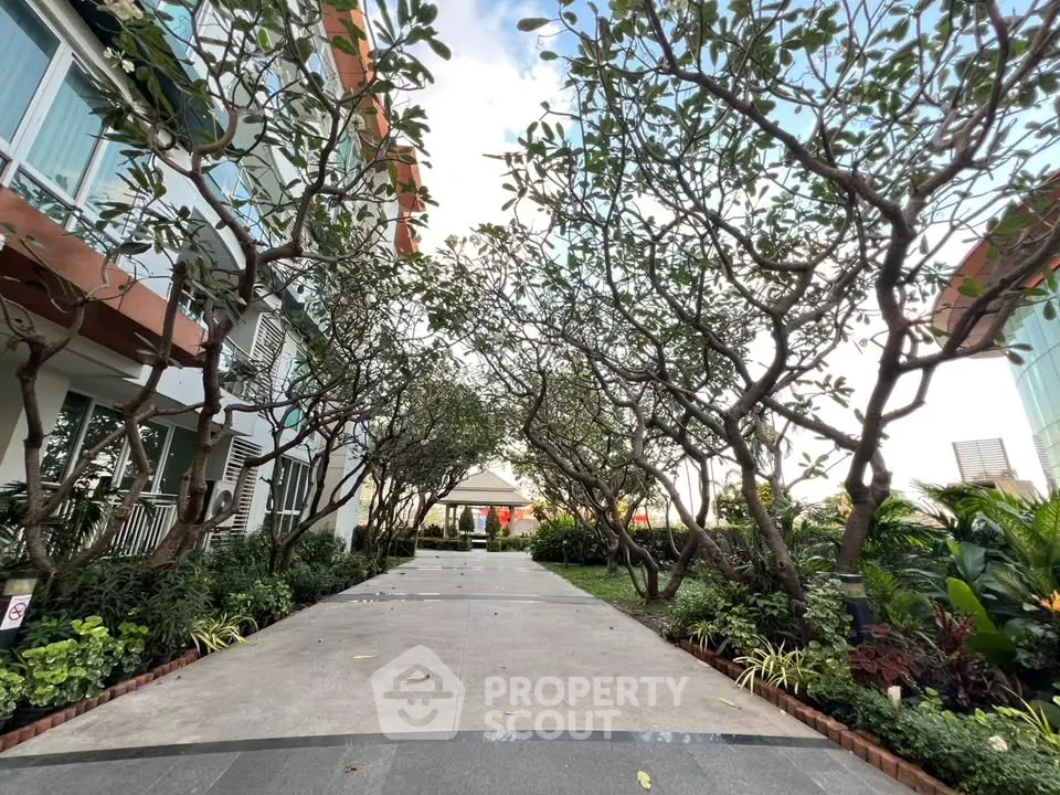 Beautiful garden pathway with lush greenery and modern building exterior