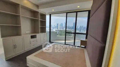 Spacious modern bedroom with city skyline view and built-in storage