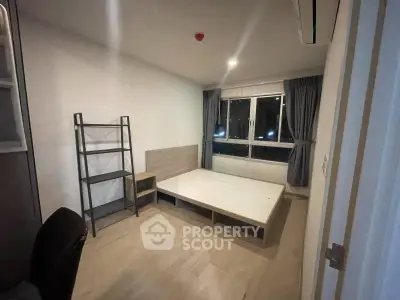 Spacious bedroom with modern design and large window offering city views.