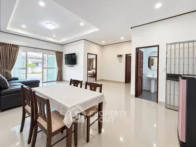 Spacious open-plan living and dining area with modern furnishings and natural light.