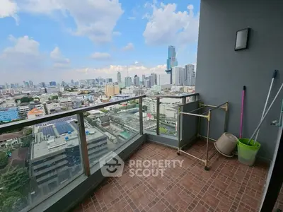Stunning city view from a high-rise balcony with modern railing and tiled flooring.