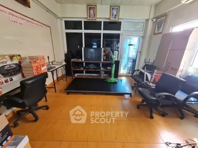 Spacious office room with modern furniture and large windows for natural light.