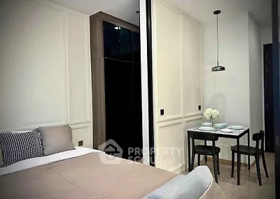 Modern bedroom with cozy dining area in stylish apartment