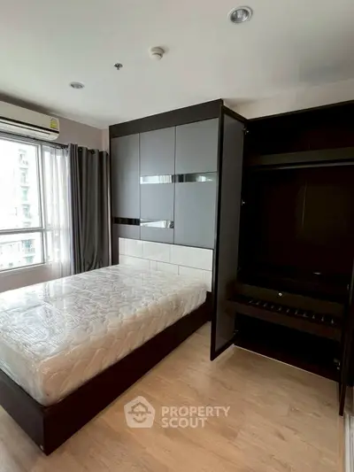 Modern bedroom with sleek black wardrobe and large window view