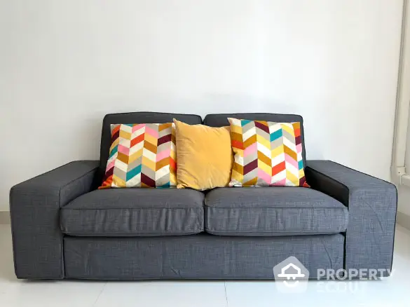 Stylish modern sofa with colorful cushions in a bright living room