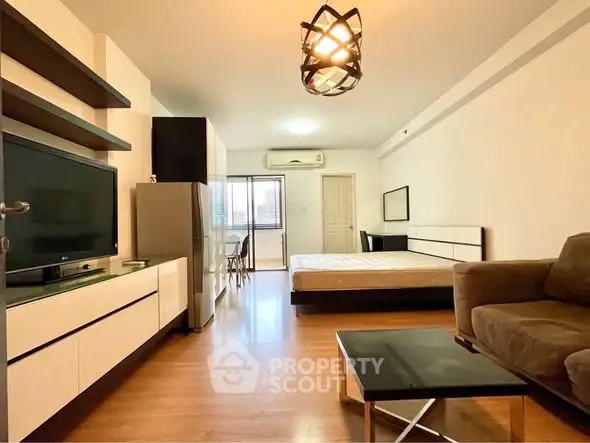 Spacious studio apartment with modern furnishings and natural light.