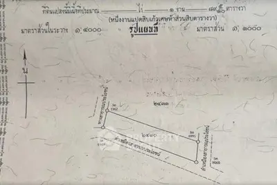 Detailed real estate plot map with measurements and orientation for property development.