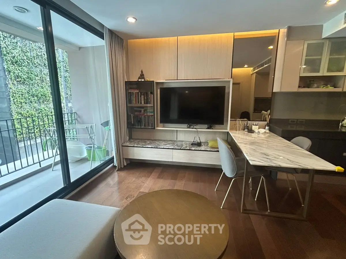 Modern living room with open kitchen and balcony access