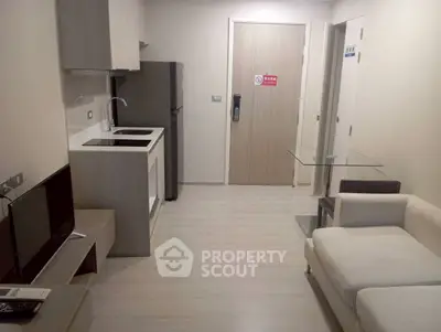 Modern compact living room with kitchenette and sleek furniture