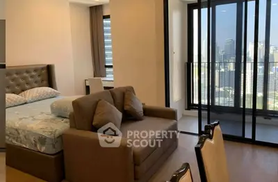 Modern bedroom with city view and stylish furniture in high-rise apartment.