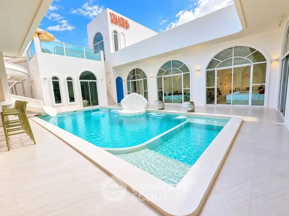 Luxurious villa with stunning pool and modern architecture, perfect for relaxation and entertainment.