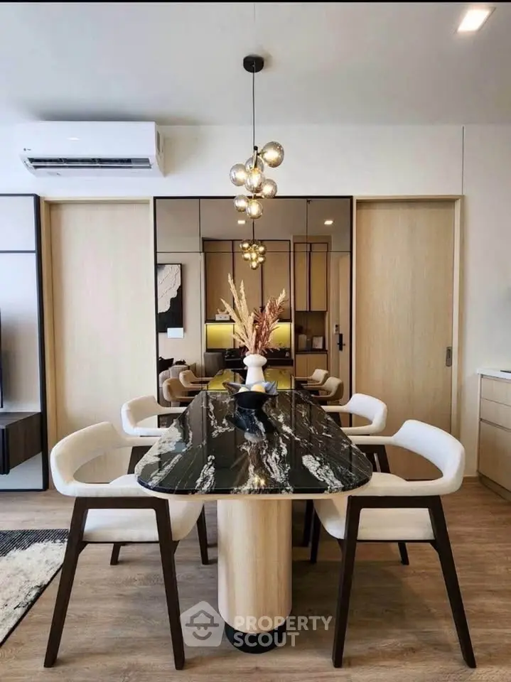 Modern dining area with elegant black marble table and stylish lighting