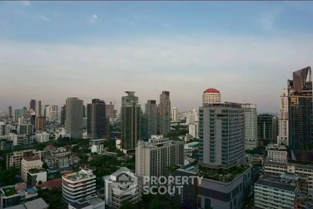 Stunning cityscape view showcasing modern high-rise buildings under a clear sky, perfect for urban living.