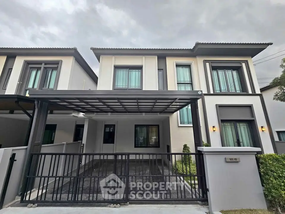 Modern two-story house with sleek design and spacious carport