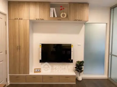 Modern living room with built-in wooden cabinets and sleek TV setup, perfect for stylish urban living.