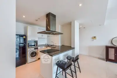 Modern kitchen with sleek appliances and breakfast bar seating