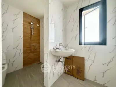 Modern bathroom with marble tiles and natural light