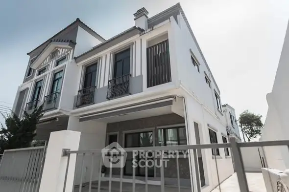 Modern two-story house with sleek design and large windows, perfect for family living.