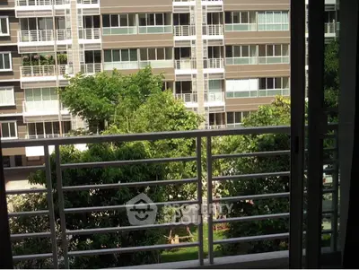 Modern apartment building with lush greenery and unique architectural design.